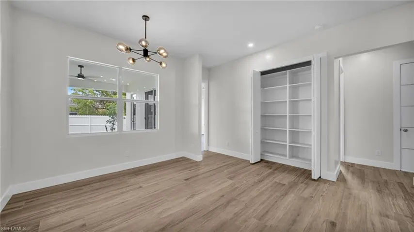 Unfurnished dining area with a chandelier, light wood-style flooring, and recessed lighting