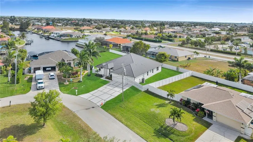 Aerial view of residential area featuring a large body of water
