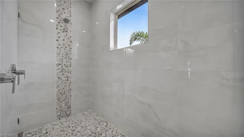 Bathroom featuring a marble finish shower