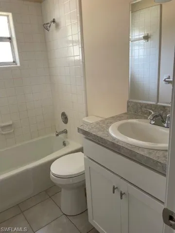 Bathroom featuring tile patterned floors, vanity, bathing tub / shower combination, and toilet