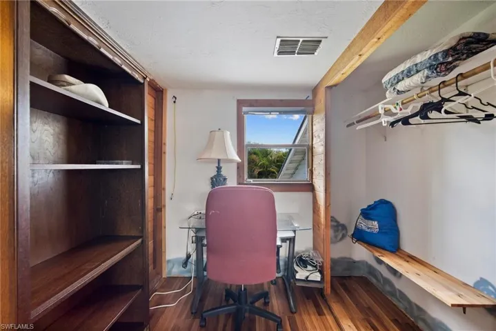 Home office featuring dark wood-type flooring