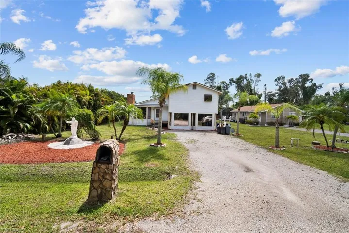 View of front of house featuring a front yard and a carport