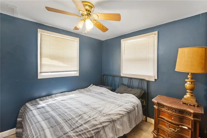 Bedroom with hardwood / wood-style flooring and ceiling fan
