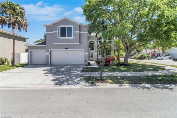 View of front of home featuring stucco siding, driveway, and an attached garage