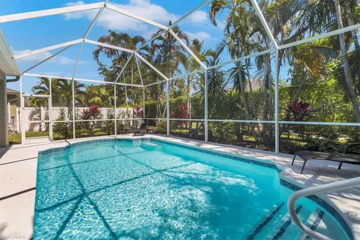 View of pool featuring a lanai, a patio area, and a fenced in pool