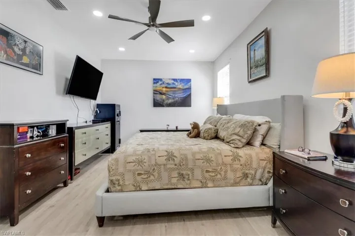 Bedroom featuring recessed lighting, light wood-style flooring, visible vents, and ceiling fan