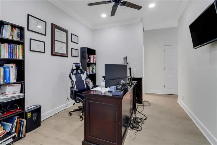 Office space with ornamental molding, a ceiling fan, recessed lighting, light wood finished floors, and baseboards