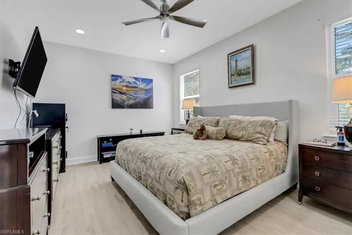 Bedroom with recessed lighting, multiple windows, and light wood finished floors