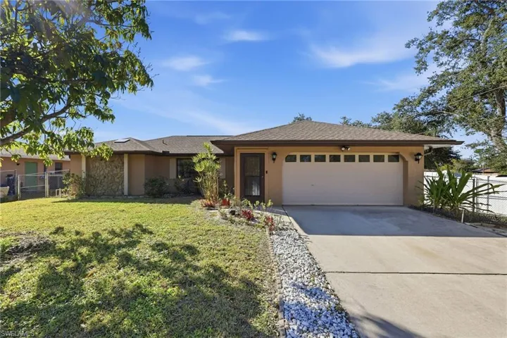 View of front of property with stucco siding, concrete driveway, a garage, stone siding, and roof with shingles