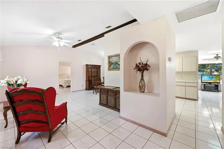Hallway featuring light tile patterned floors and baseboards