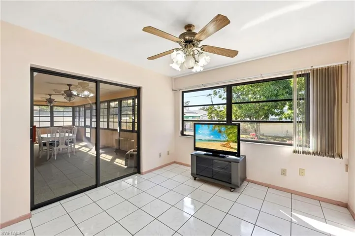 Unfurnished living room with a ceiling fan and light tile patterned floors