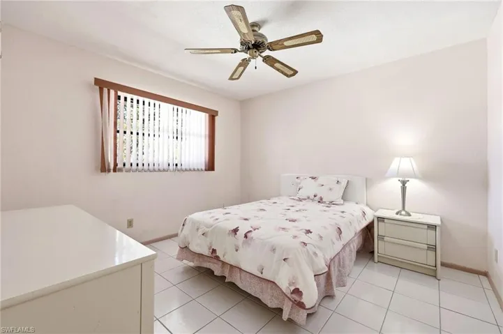 Bedroom featuring a ceiling fan and light tile patterned flooring