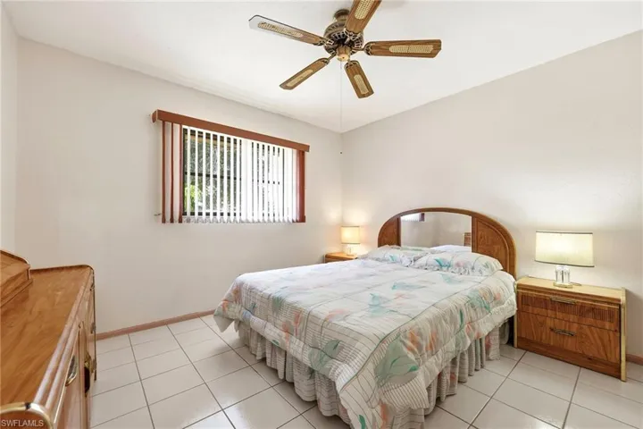 Bedroom featuring a ceiling fan and light tile patterned flooring