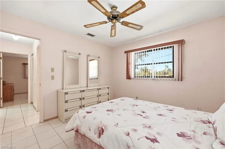 Bedroom featuring light tile patterned floors and a ceiling fan
