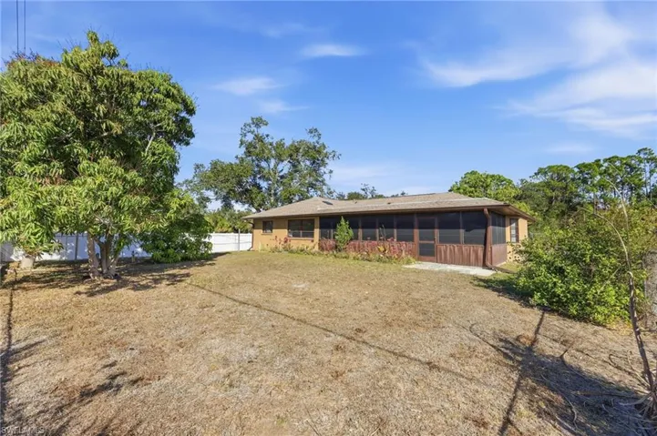 Back of property with a sunroom