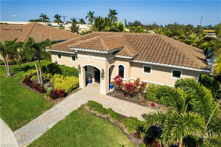 Mediterranean-style residence featuring a tile roof and stucco exterior