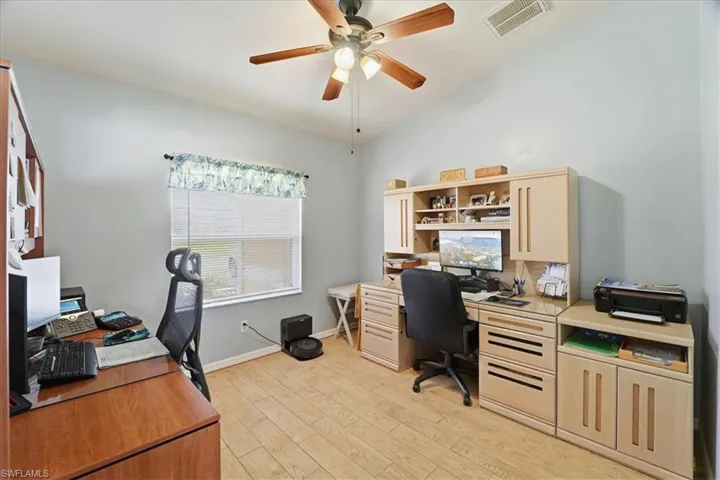 Office with light wood finished floors, lofted ceiling, and ceiling fan