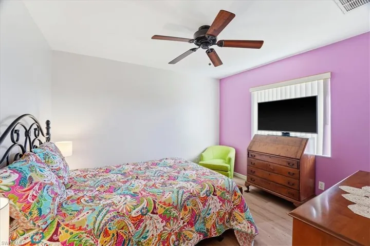 Bedroom with light wood finished floors and ceiling fan