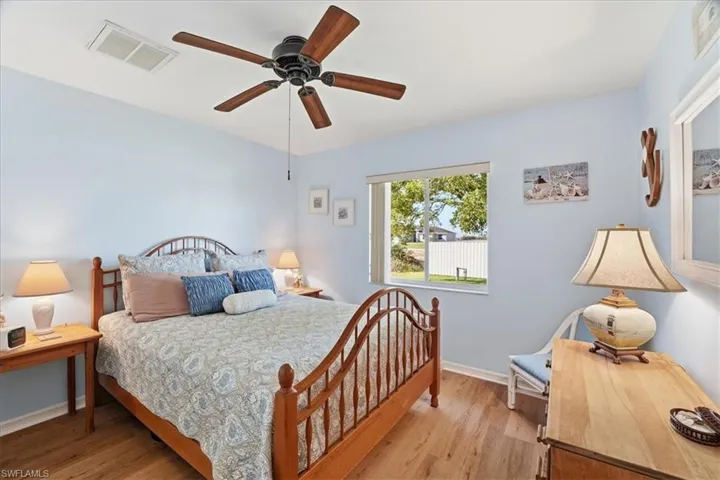 Bedroom with wood finished floors and ceiling fan