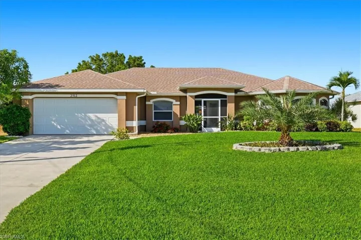View of front of home featuring concrete driveway, stucco siding, a front yard, a garage, and a shingled roof