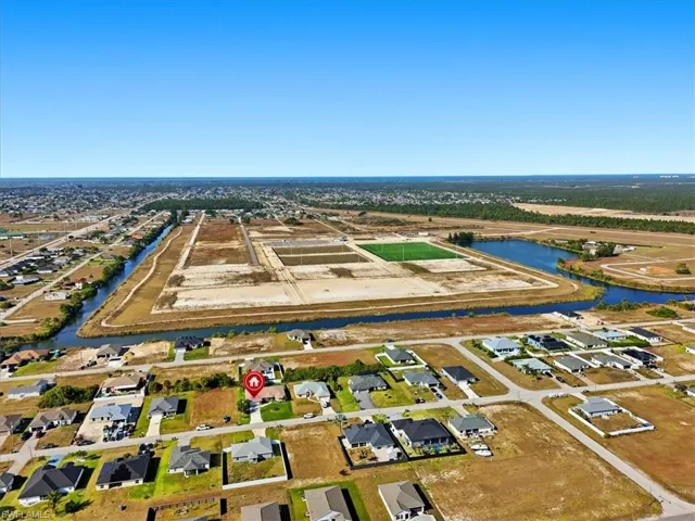 View of property location featuring a nearby body of water and nearby suburban area