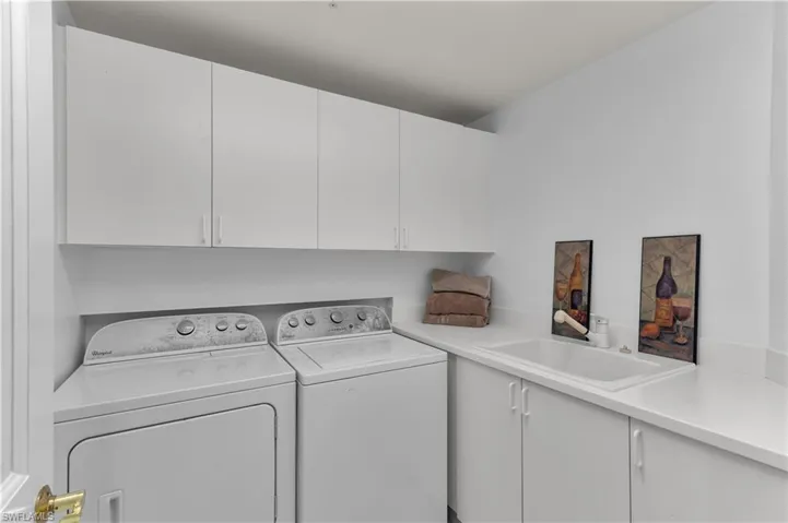 Laundry room featuring cabinet space and separate washer and dryer