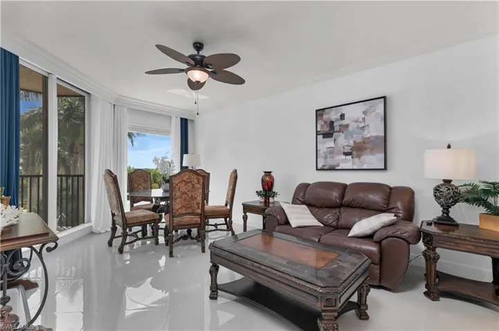 Living area featuring crown molding and a ceiling fan