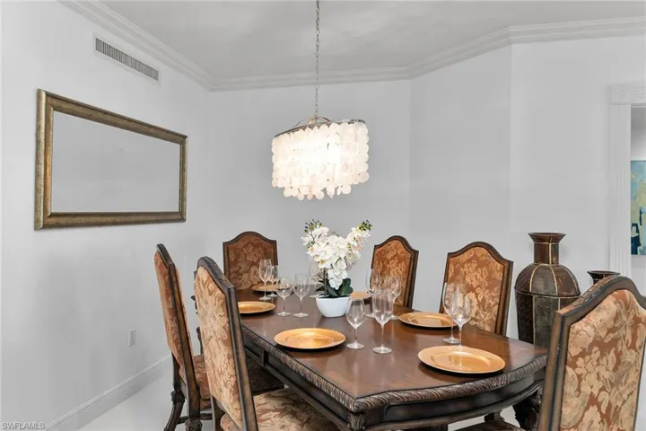 Dining room featuring crown molding and a chandelier