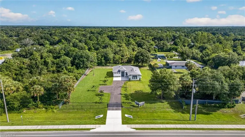 Contemporary single-story residence with a gray tile roof and white exterior
