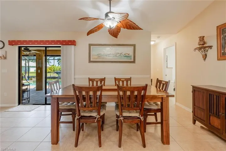 Dining space featuring light tile flooring and ceiling fan