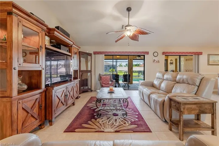Tiled living room featuring ceiling fan