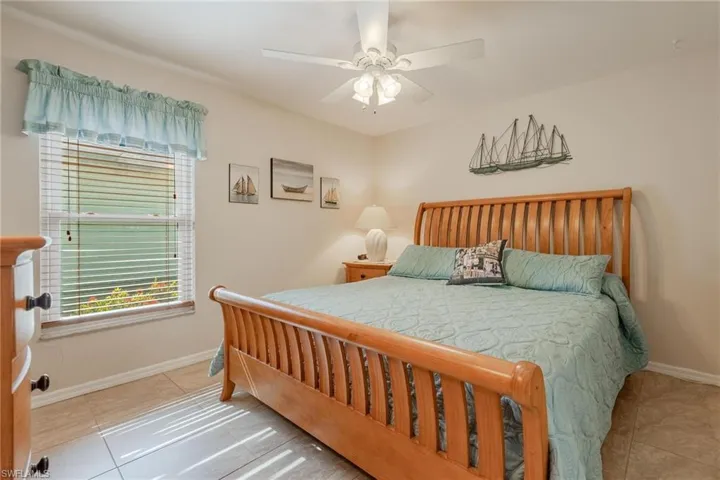 Bedroom with tile floors and ceiling fan