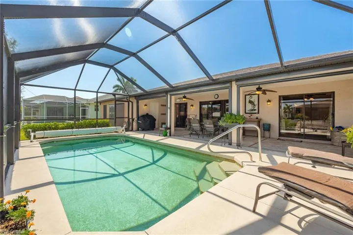 View of swimming pool featuring a patio, a lanai, and ceiling fan