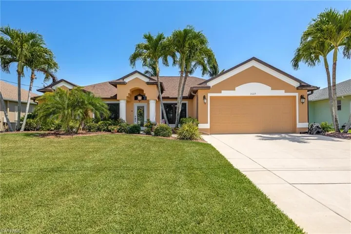 Single story home featuring a front yard and a garage
