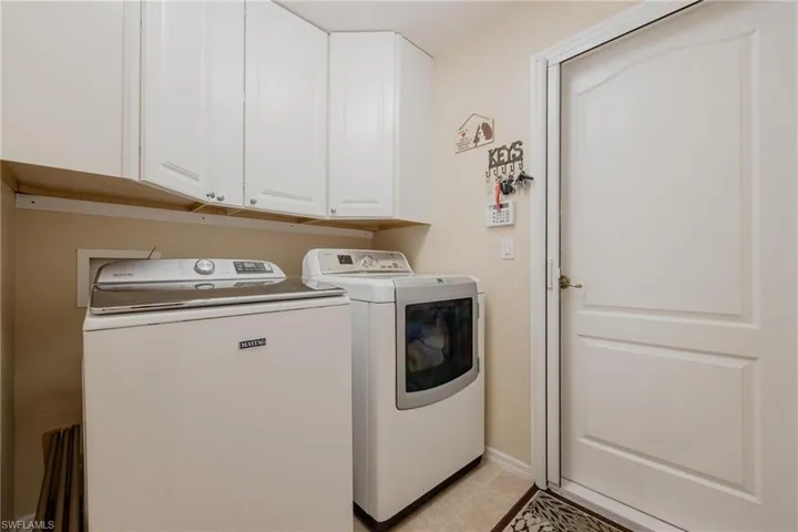 Laundry Room featuring washer and dryer, extra cabinets