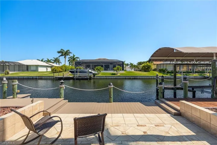 Dock area with a lanai and a water view