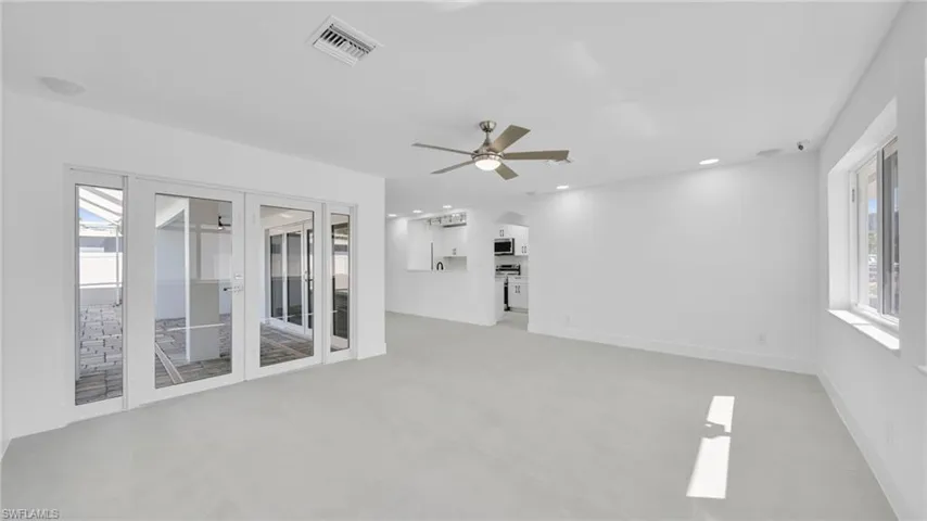 Spare room featuring plenty of natural light, ceiling fan, recessed lighting, and french doors