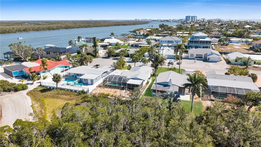 Aerial perspective of suburban area with a nearby body of water