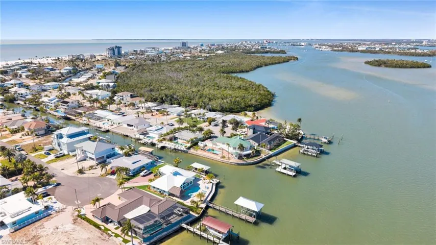 Aerial view of property's location featuring a large body of water and nearby suburban area