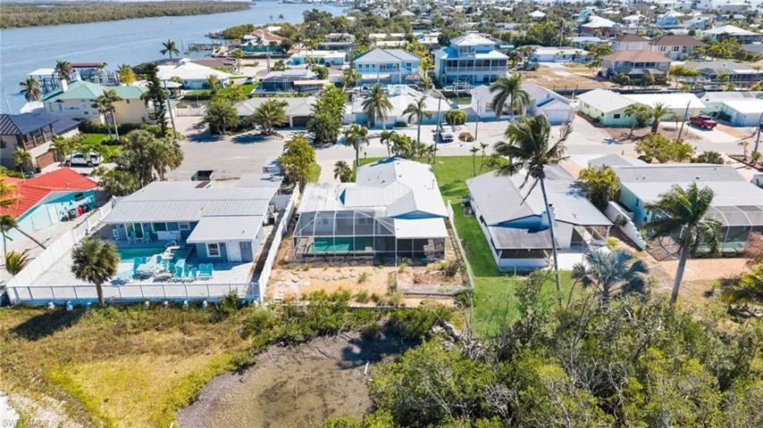 Aerial perspective of suburban area with a nearby body of water