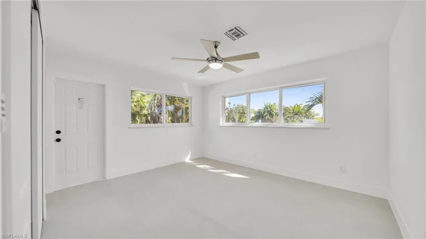 Spare room featuring healthy amount of natural light and ceiling fan