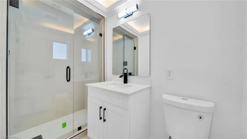 Bathroom featuring vanity and a shower stall