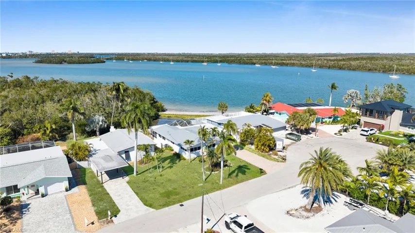 Aerial perspective of suburban area featuring a large body of water