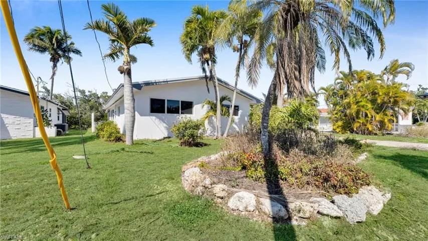 View of property exterior with a yard and stucco siding