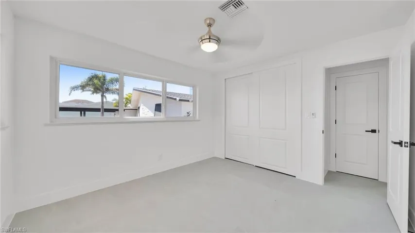 Unfurnished bedroom featuring a closet and finished concrete flooring