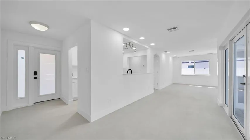 Entrance foyer with concrete flooring and recessed lighting