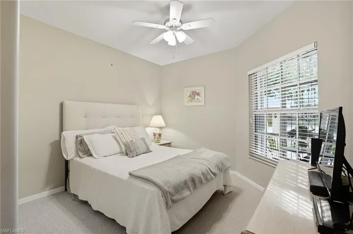 Bedroom featuring light colored carpet and a ceiling fan