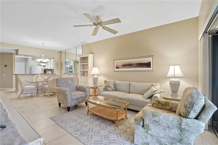 Tiled living room featuring a ceiling fan