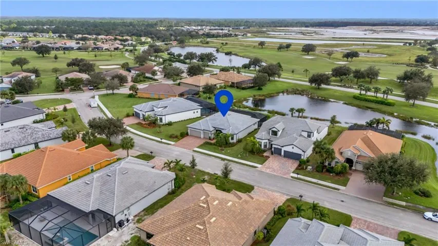 Birds eye view of property with a water view