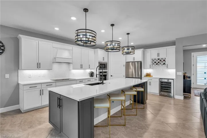 Kitchen with appliances, granite sink, oversized island, 2 trash can pull outs and pull out drawers inside cabinets